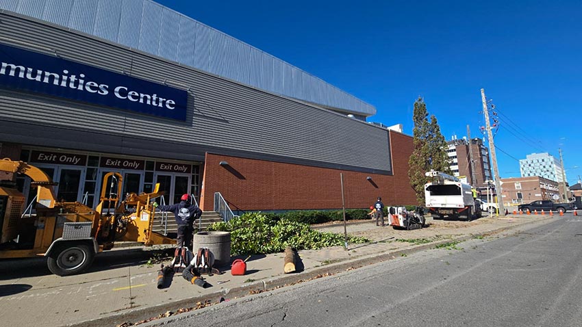 Forestry truck and wood chipper positioned outside Tribute Communities Centre